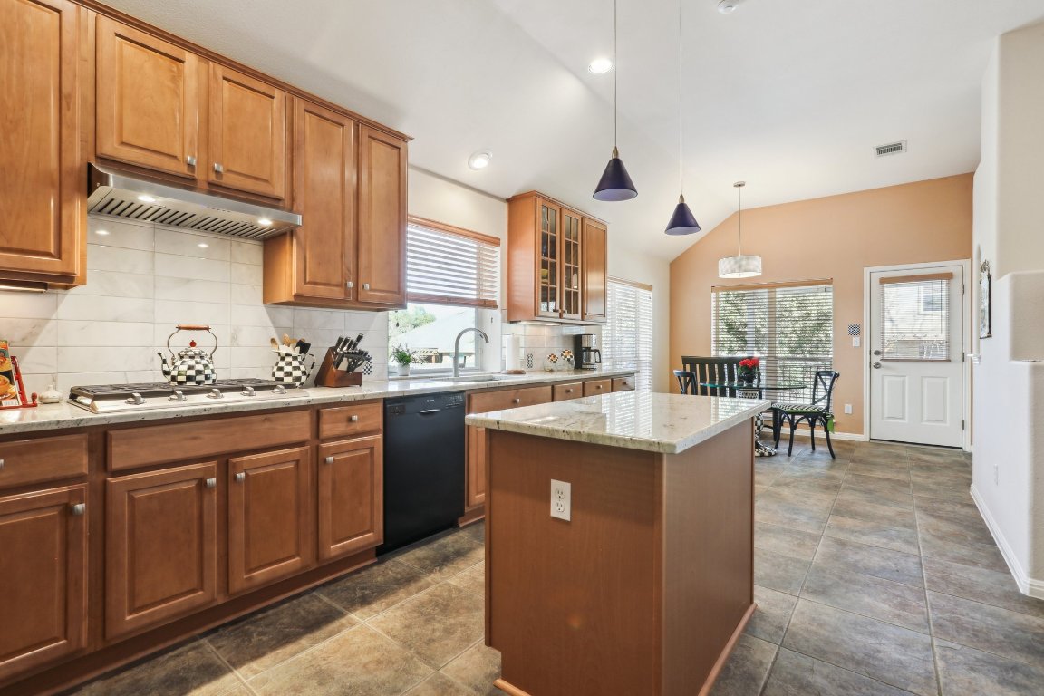 3805 Pebble Court Round Rock, TX 78664 - Photo 15 of 31 a kitchen with stainless steel appliances granite countertop a sink a stove and a refrigerator
