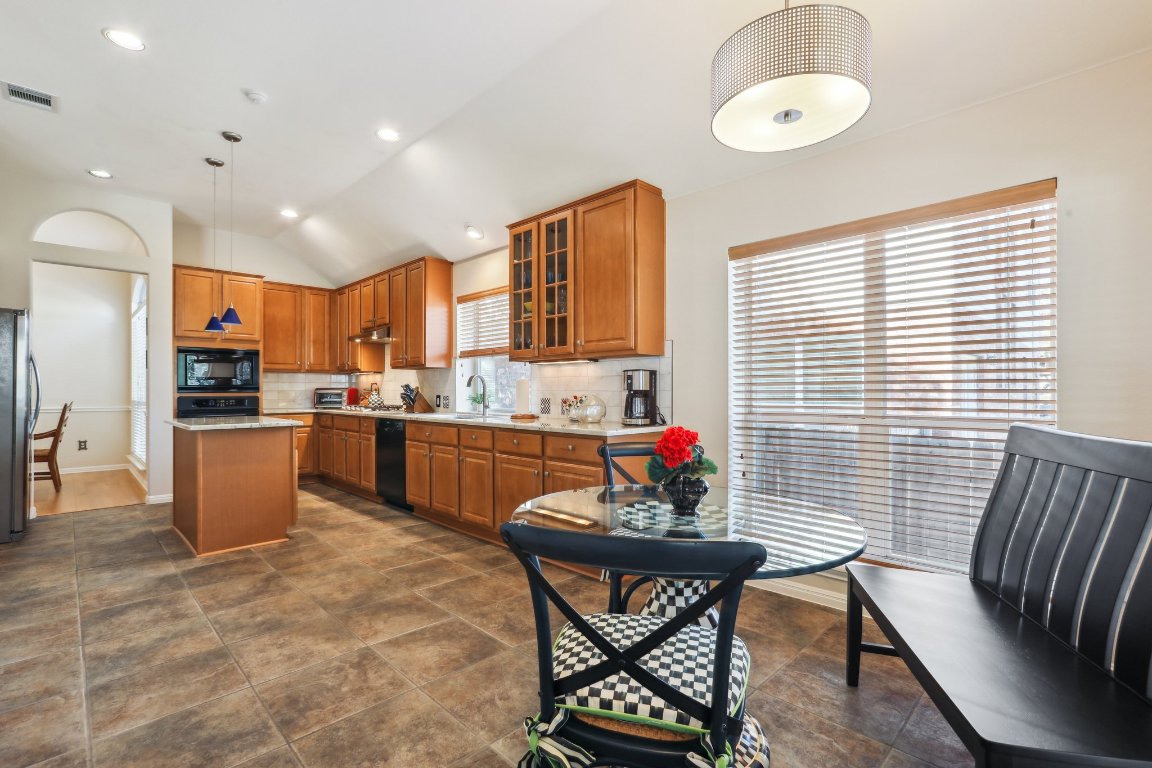 3805 Pebble Court Round Rock, TX 78664 - Photo 18 of 31 a kitchen with stainless steel appliances kitchen island granite countertop a sink and cabinets