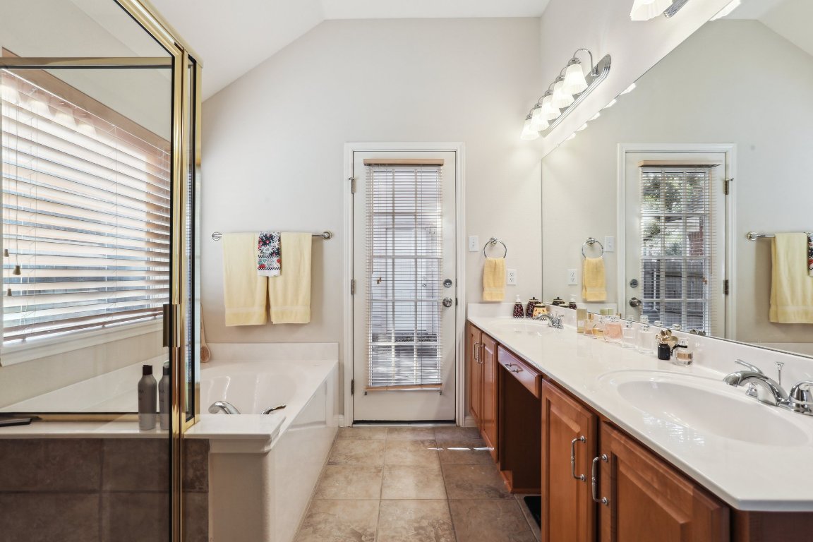 3805 Pebble Court Round Rock, TX 78664 - Photo 25 of 31 a spacious bathroom with a double vanity sink a mirror and a shower