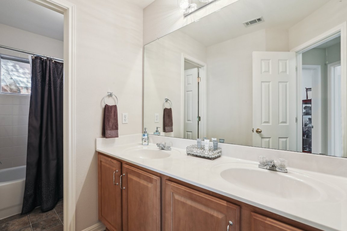 3805 Pebble Court Round Rock, TX 78664 - Photo 9 of 31 a bathroom with double vanity sinks and a mirror