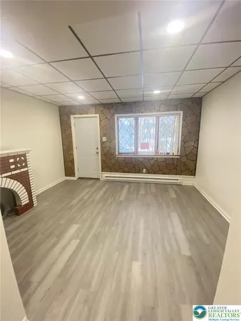 a room with stainless steel appliances kitchen island a cabinets and wooden floor