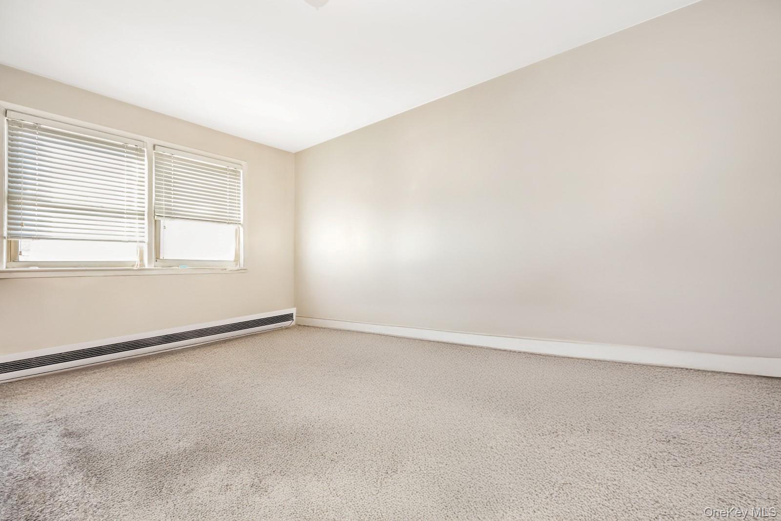 60-56 75th Street Queens, NY 11379 - Photo 11 of 30 an empty room with a window