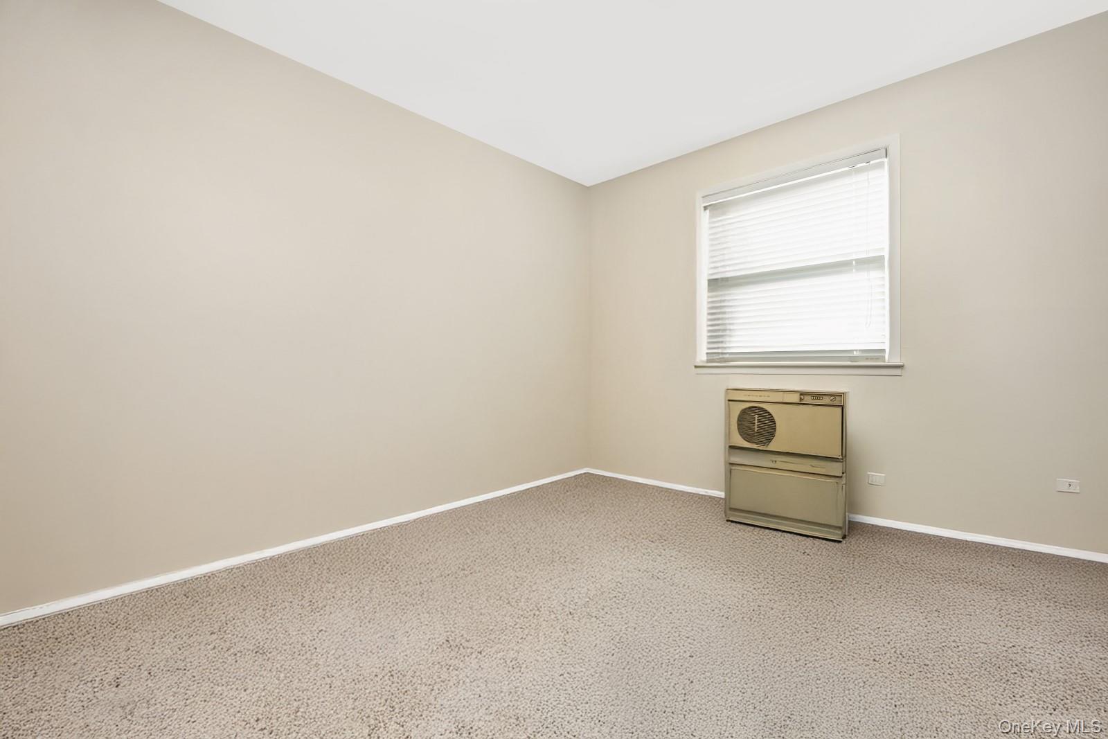 60-56 75th Street Queens, NY 11379 - Photo 12 of 30 an empty room with a window