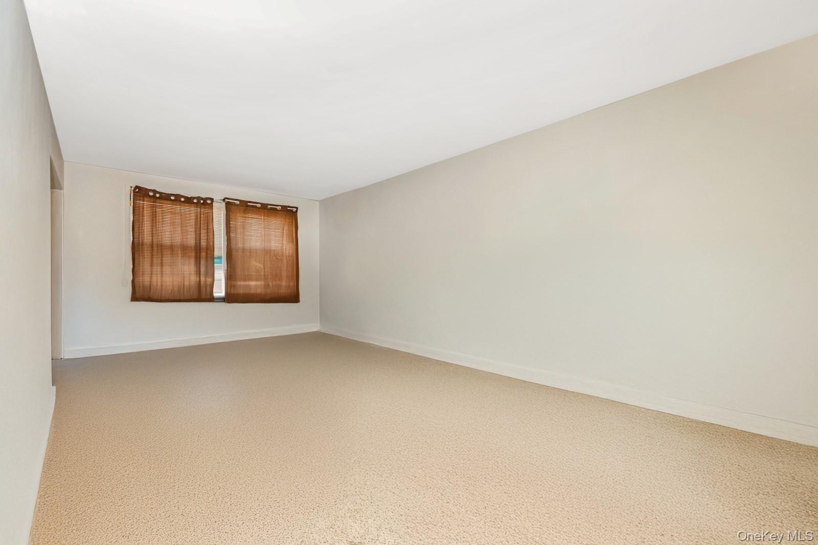 60-56 75th Street Queens, NY 11379 - Photo 13 of 30 an empty room with windows