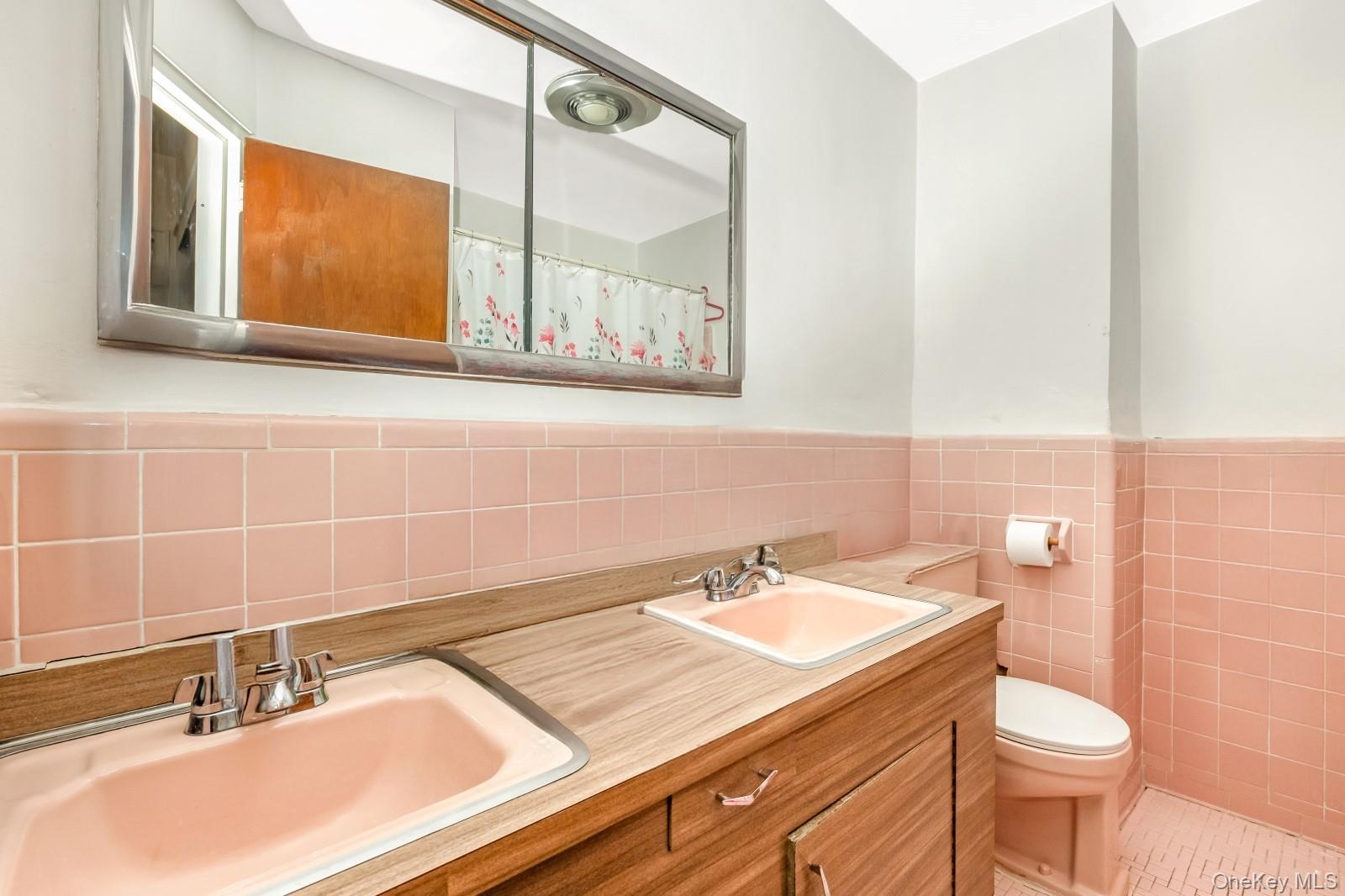60-56 75th Street Queens, NY 11379 - Photo 19 of 30 a bathroom with a sink and a mirror