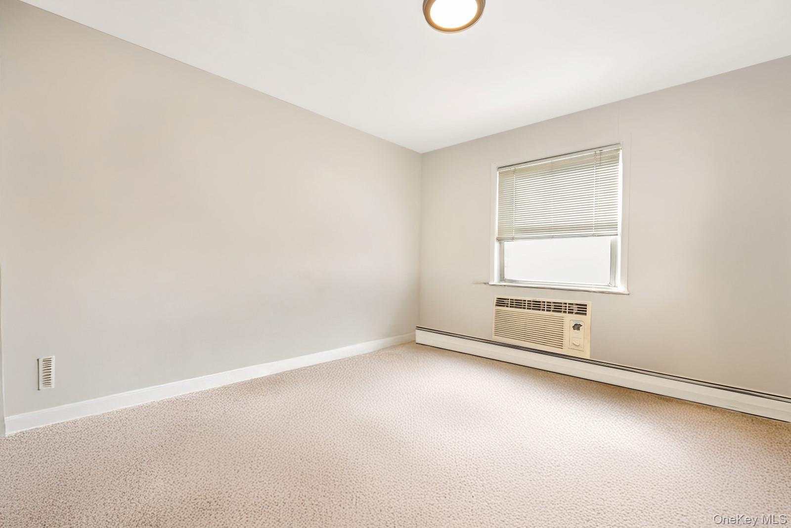 60-56 75th Street Queens, NY 11379 - Photo 21 of 30 an empty room with windows