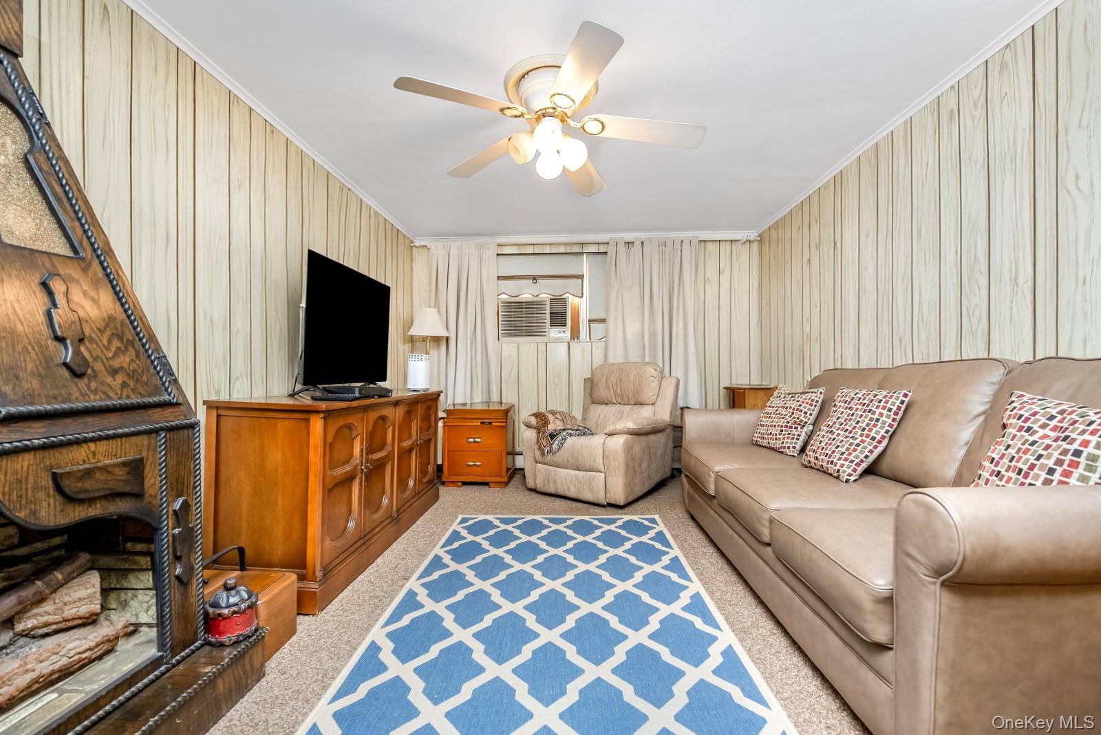 60-56 75th Street Queens, NY 11379 - Photo 23 of 30 a living room with furniture and a flat screen tv