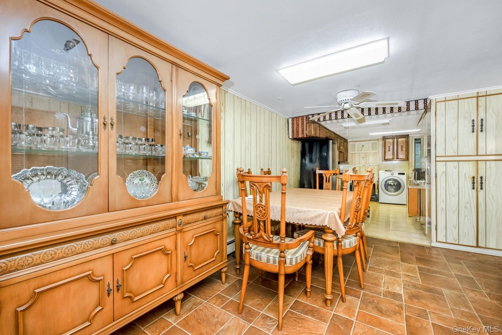 60-56 75th Street Queens, NY 11379 - Photo 25 of 30 a view of a dining area with furniture and chandelier