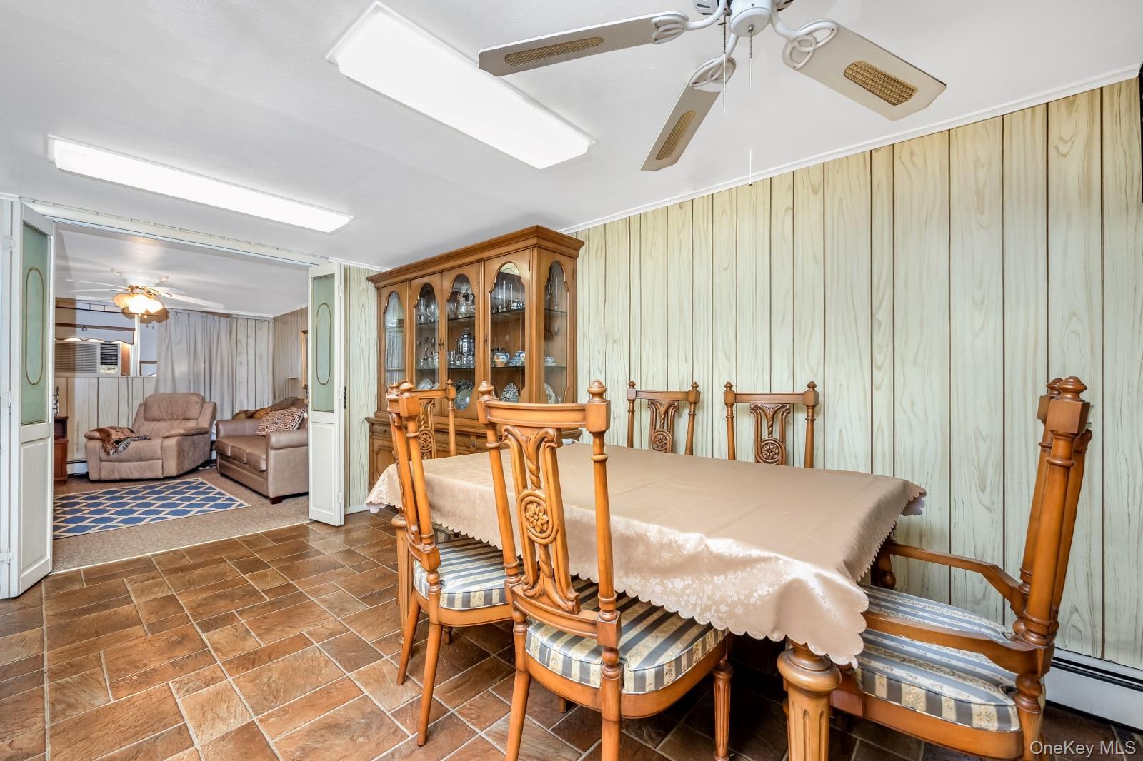 60-56 75th Street Queens, NY 11379 - Photo 26 of 30 a view of a dining room with furniture and a chandelier