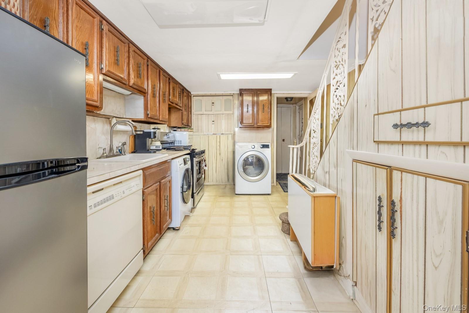 60-56 75th Street Queens, NY 11379 - Photo 27 of 30 a kitchen with a refrigerator a stove top oven and cabinets