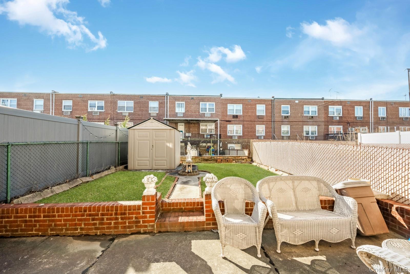 60-56 75th Street Queens, NY 11379 - Photo 29 of 30 a front view of a house with outdoor seating