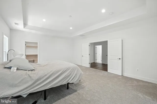 a bedroom with a bed and mirror