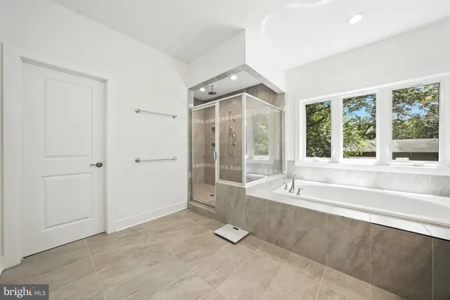 a spacious bathroom with a tub and shower