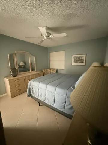 a bedroom with a large bed and a flat screen tv