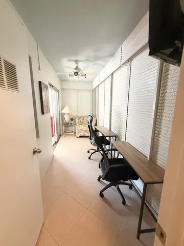 a view of a room with chairs and a window