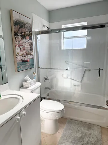 a white toilet sitting next to a bathroom sink