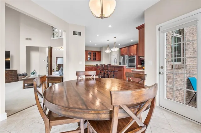 a dining room with furniture and a floor to ceiling window