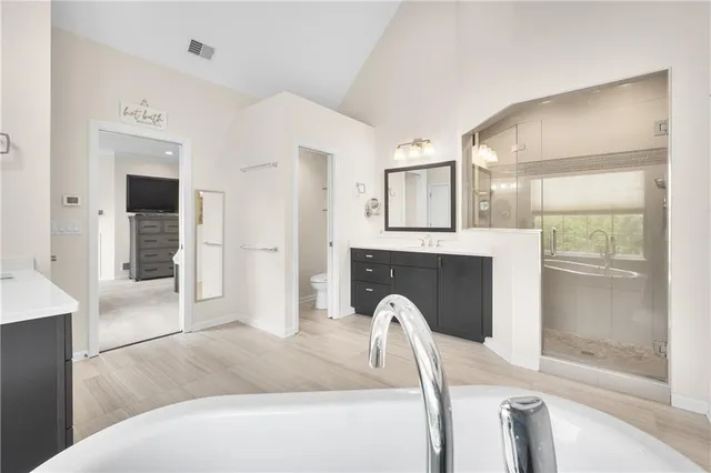 a living room with furniture a fireplace and a large window
