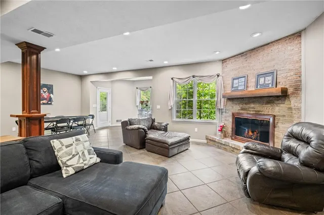 a living room with furniture large window and a fireplace