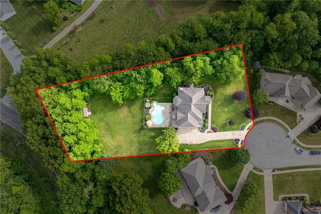 an aerial view of a house with garden space and street view