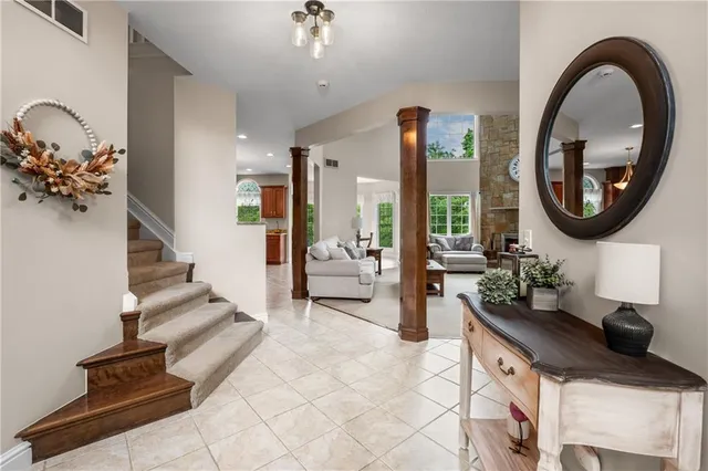 a living room with furniture and a mirror