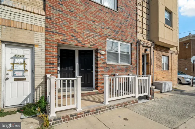 a view of a brick house with a large window