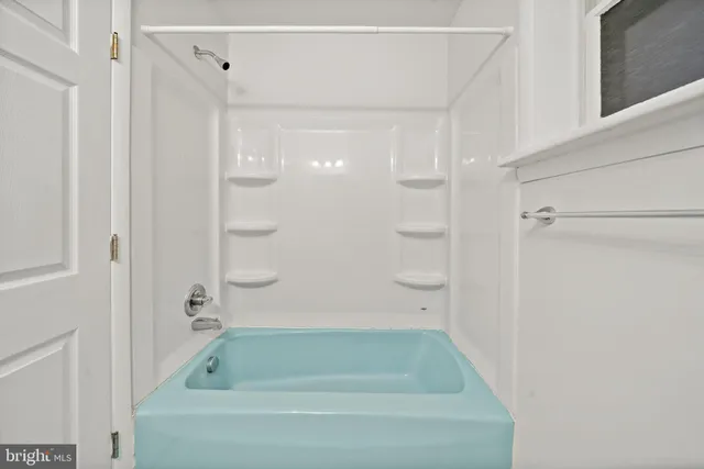 a bathroom with a shower and a bath tub