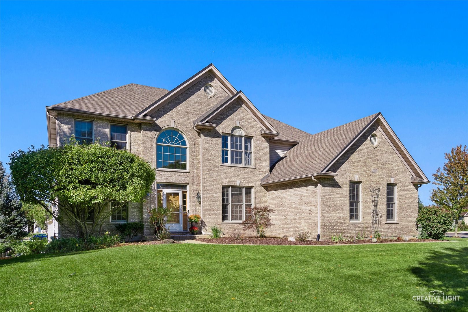 201 Violet Lane Batavia, IL 60510 - Photo 2 of 47 a front view of a house with a yard and porch