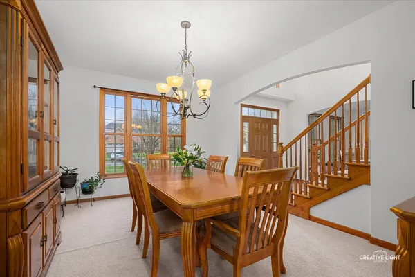 a large kitchen with a table and chairs