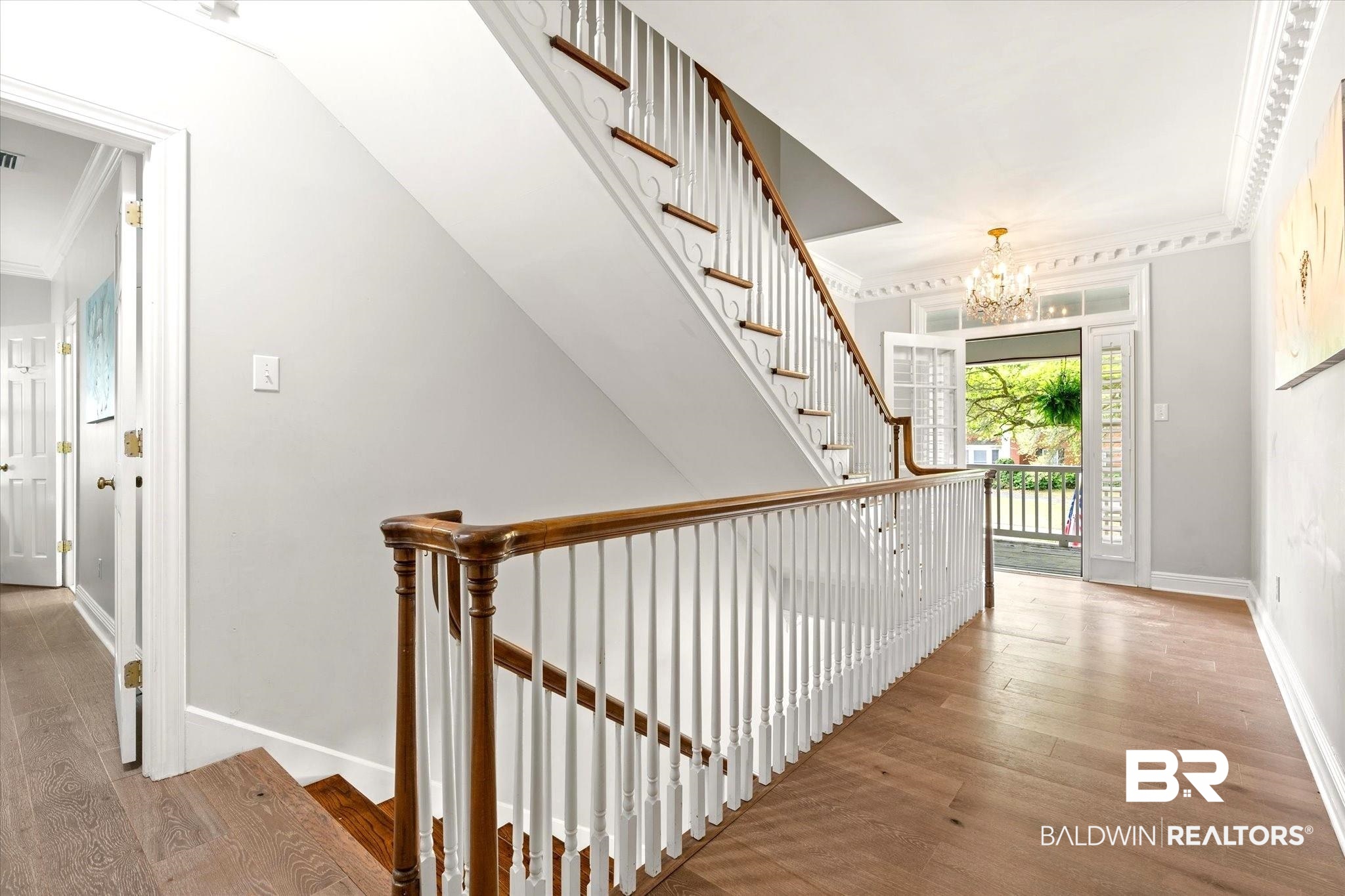 5324 Oak Bend Court Mobile, AL 36609 - Photo 19 of 49 Hall with baseboards, an inviting chandelier, crown molding, and wood finished floors