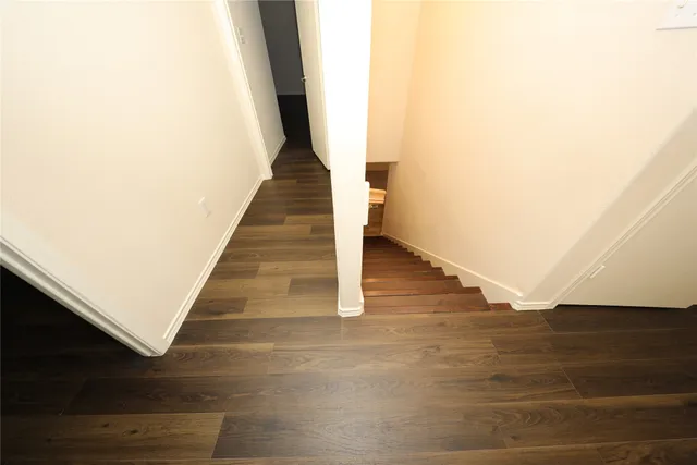 a view of entryway and hall with wooden floor