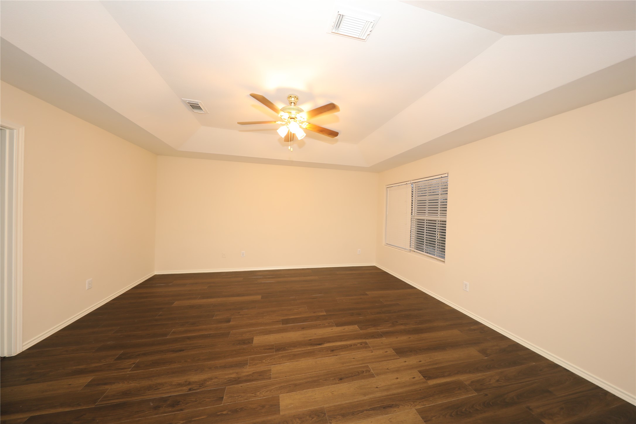 12620 Rio Bravo Street Rosharon, TX 77583 - Photo 17 of 25 an empty room with wooden floor and windows
