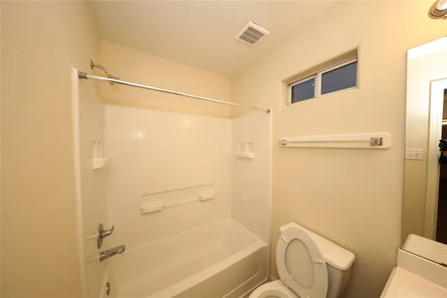 a bathroom with a shower and a toilet
