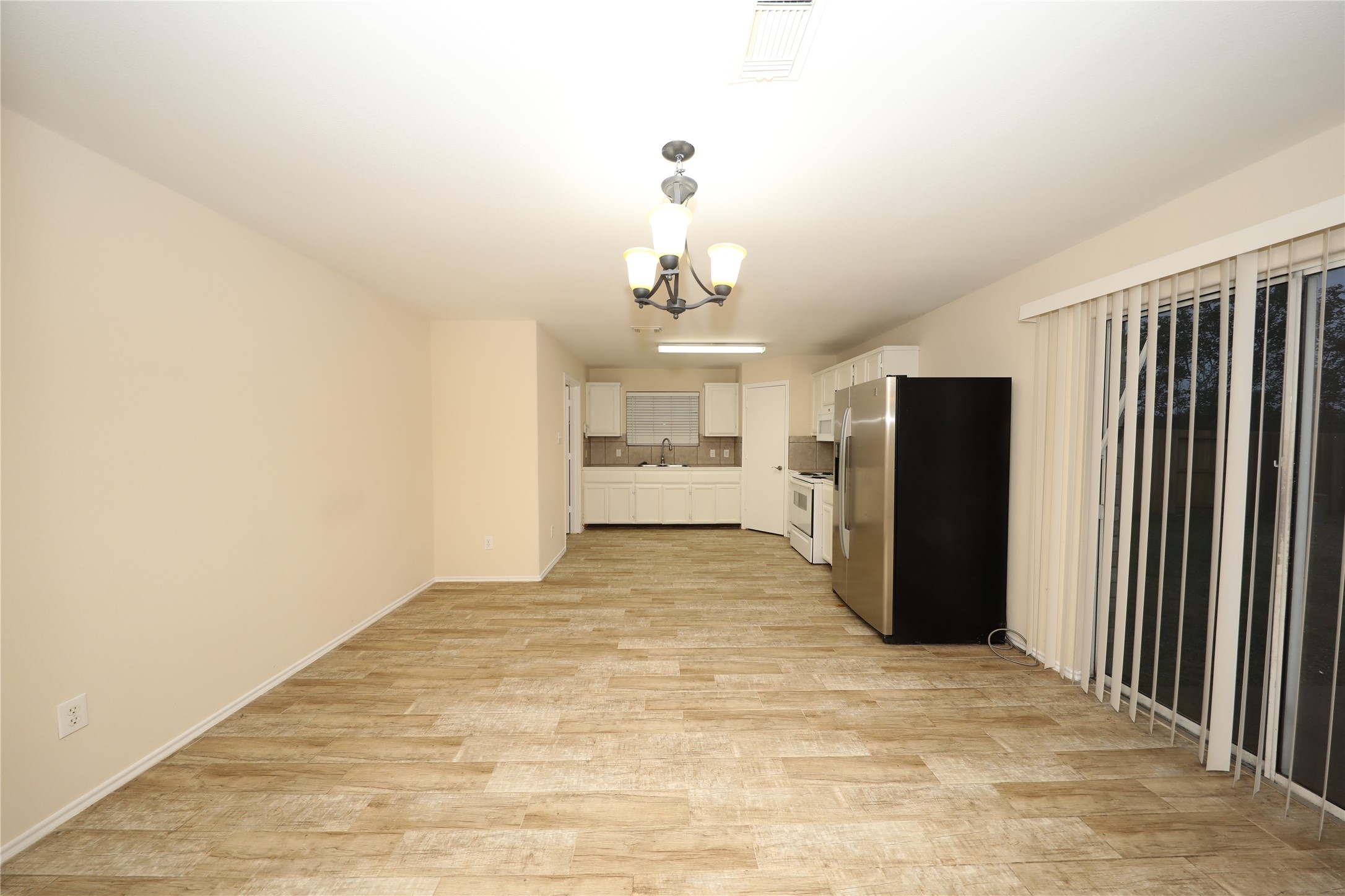 12620 Rio Bravo Street Rosharon, TX 77583 - Photo 5 of 25 a view of a kitchen with refrigerator and windows