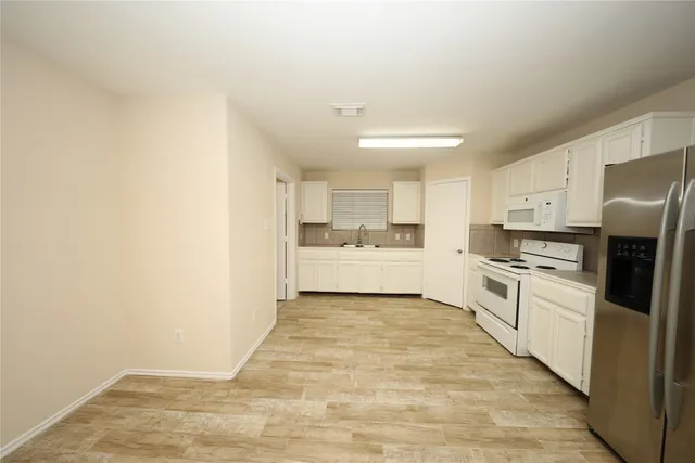a kitchen with a sink stainless steel appliances and cabinets