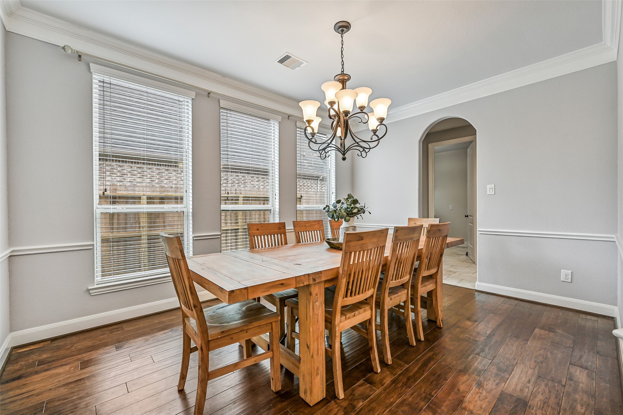 1008 Point Isabel Lane Friendswood, TX 77546 - Photo 11 of 50 A second angle highlights the room’s proportions and natural light from a trio of side facing windows. The layout allows for larger gatherings while maintaining a comfortable connection to the adjoining butlers pantry and kitchen.