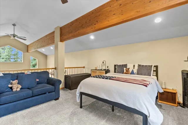 a spacious bedroom with a bed and a couch