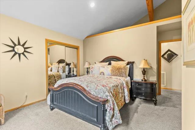 a bedroom with a bed and a painting on the wall