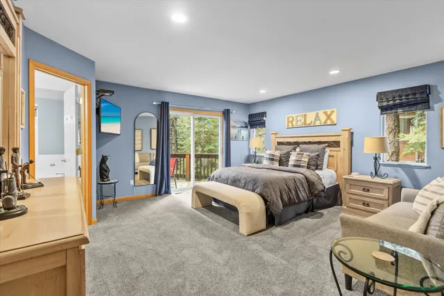 a bedroom with a large bed and a couch