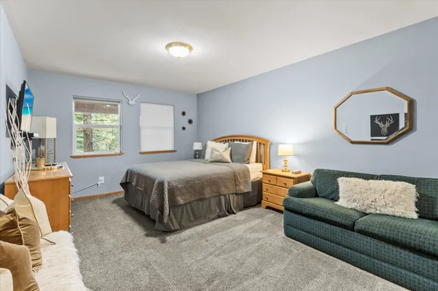 a bedroom with a bed couch and window