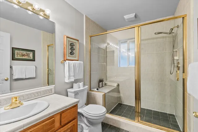 a bathroom with a sink toilet and shower