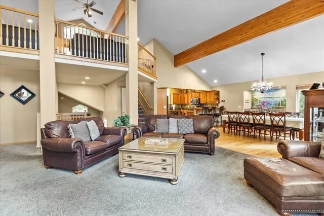 a living room with furniture and a view of kitchen