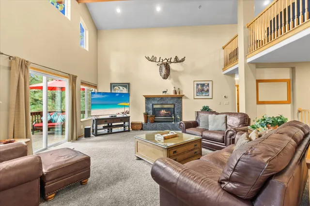 a living room with fireplace furniture and a flat screen tv
