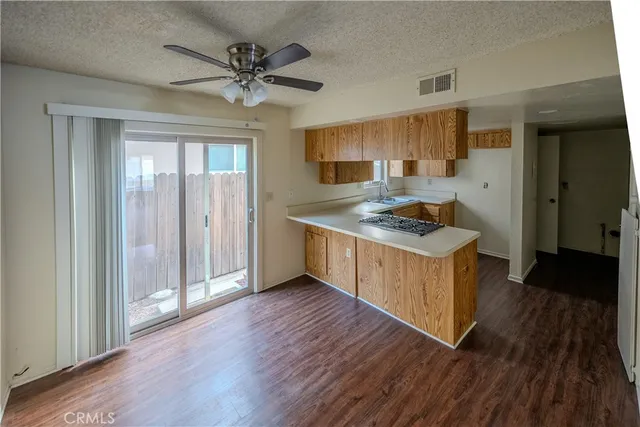 an empty room with a window and a ceiling fan