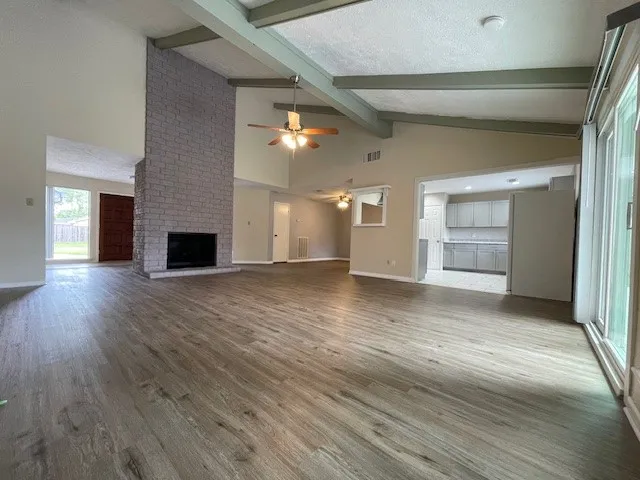 wooden floor in an empty room with a fireplace