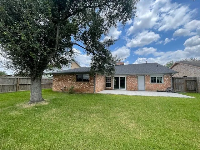 a tree in front of a white house