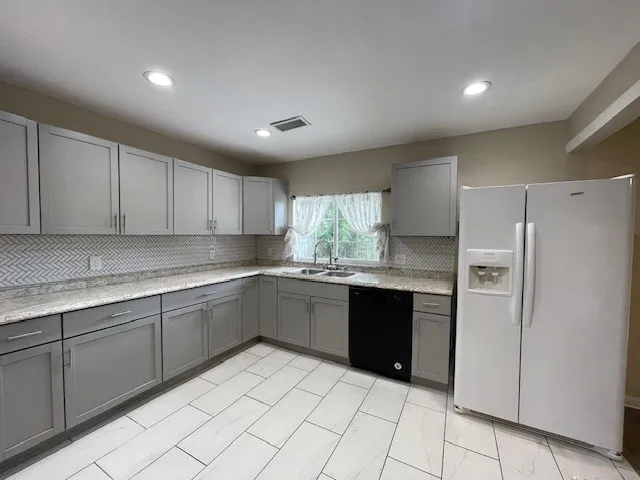 a kitchen with sink and refrigerator