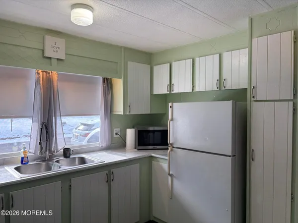 a white refrigerator freezer sitting in a kitchen