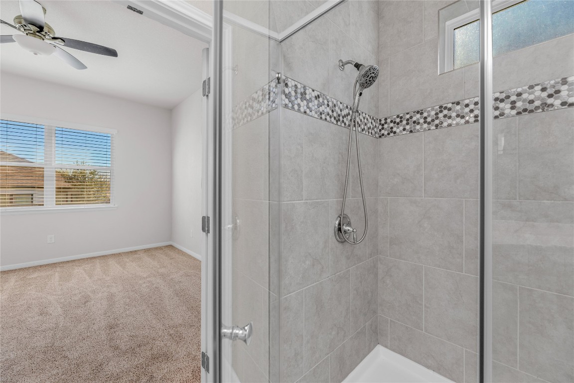9941 Comely Bend Manor, TX 78653 - Photo 13 of 31 a bathroom with a shower