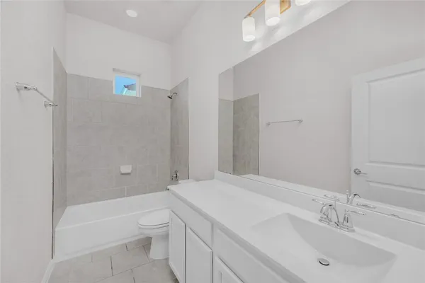 a bathroom with a bathtub shower sink and toilet
